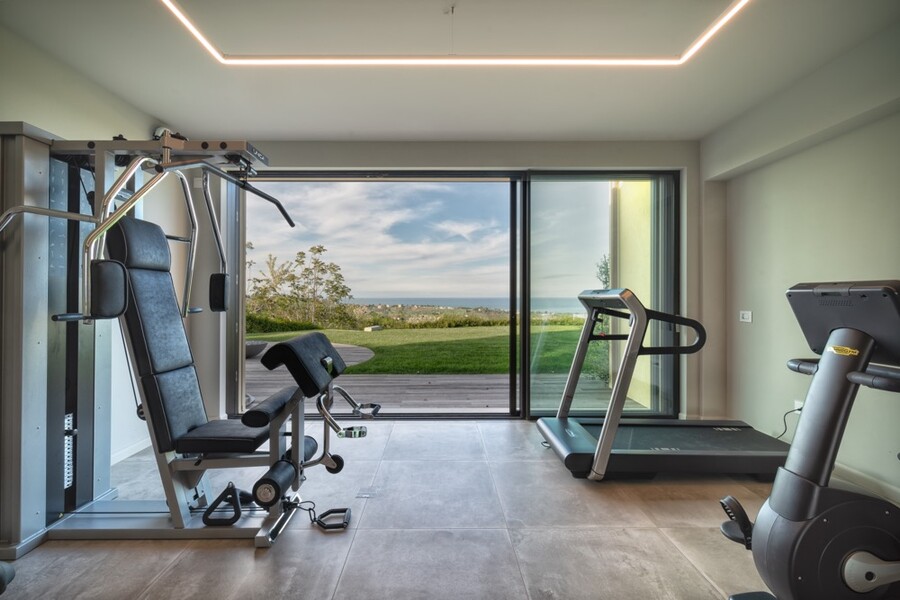 Private Gym with Technogym Equipment Villa Olivo Photo credit Davide Bischeri.