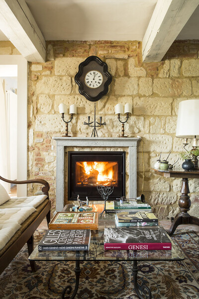 Open fireplace in the livingroom of the holiday home Cascina Monferrato